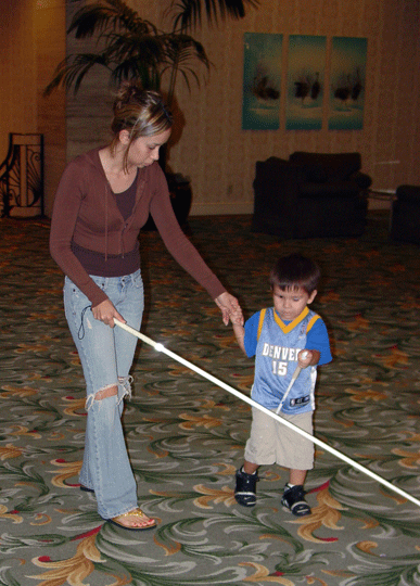 Two beneficiaries of Mr. Cutter�s training, Melissa Fernandez introduces her son Jacob Trevino to the benefits of the white cane.