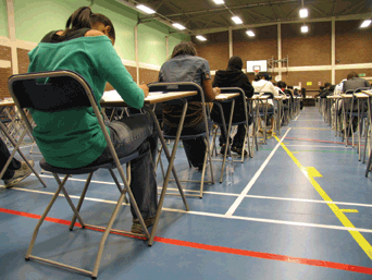 A classroom full of students work at their desks.