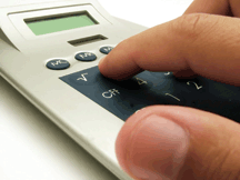 Hand on a calculator.