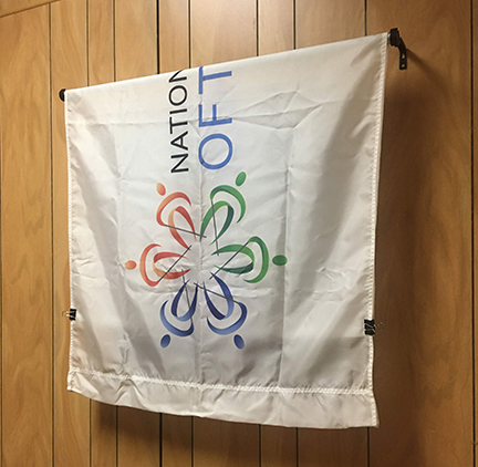 A Federation flag hangs to hide the new portrait before its unveiling