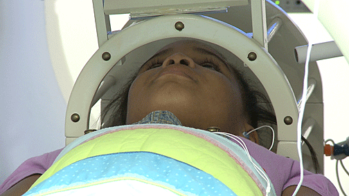 Before the actual scan begins, a child practices lying still in the mock scanner.
