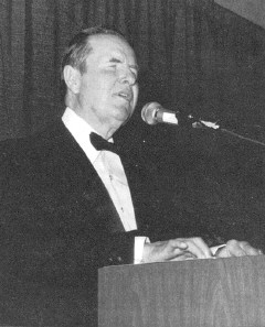 Photo of Dr. Jernigan, dressed in a tuxedo, addressing
the National Convention of the Blind. The caption reads: Kenneth Jernigan, November 13,
1926, October 12, 1998